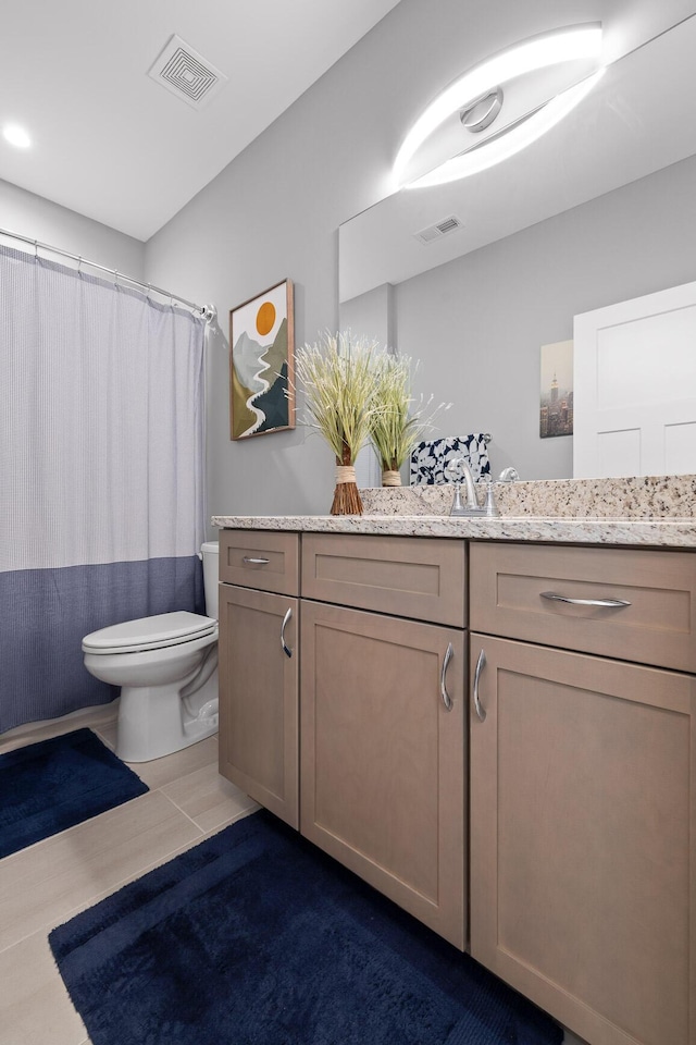 full bathroom with visible vents, toilet, vanity, and tile patterned flooring