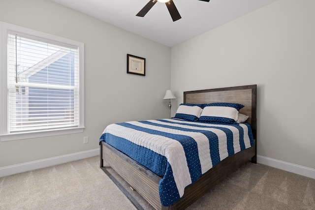 carpeted bedroom with a ceiling fan and baseboards