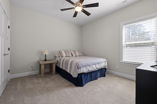 bedroom featuring visible vents, baseboards, a ceiling fan, and carpet flooring