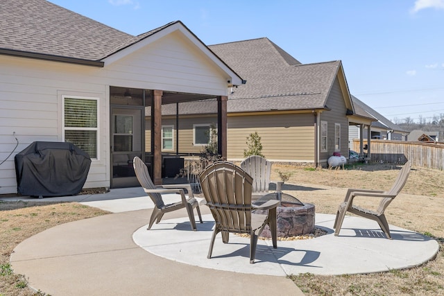 view of patio with grilling area, an outdoor fire pit, and fence