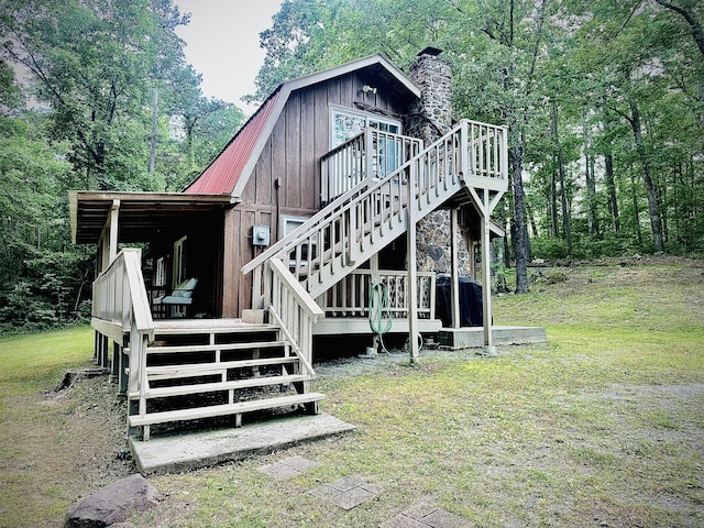 142 Huckleberry Trl, Lafayette, GA 30728 - rear view of property with stairs, a gambrel roof, a chimney, a deck, and metal roof