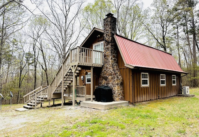 142 Huckleberry Trl, Lafayette, GA 30728 - back of property featuring board and batten siding, stairway, a chimney, metal roof, and a yard