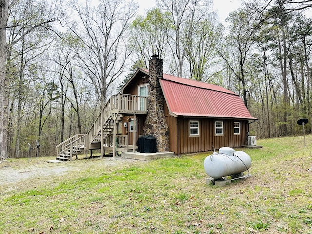 142 Huckleberry Trl, Lafayette, GA 30728 - view of home's exterior with stairway, board and batten siding, metal roof, a chimney, and a deck