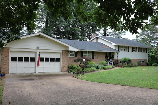 split level home with brick siding, an attached garage, a front yard, a chimney, and driveway