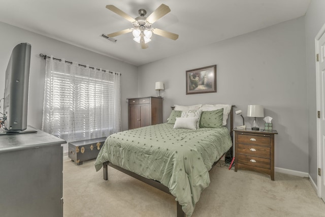 bedroom with visible vents, light carpet, baseboards, and ceiling fan