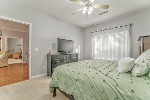 bedroom with carpet, baseboards, visible vents, and a ceiling fan