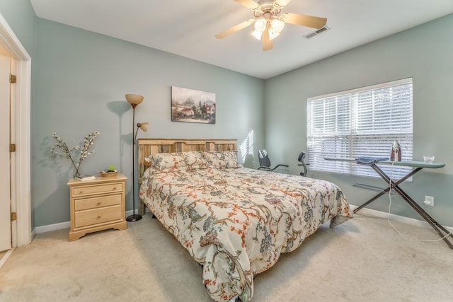 bedroom featuring light carpet, visible vents, ceiling fan, and baseboards