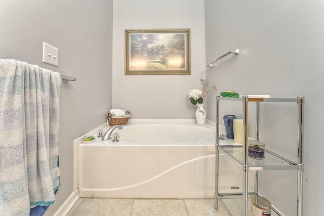 bathroom featuring tile patterned floors and a bath