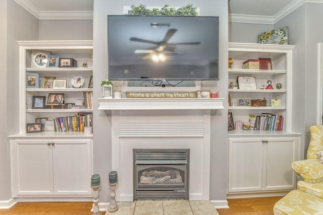 interior space with a tile fireplace, wood finished floors, and ornamental molding