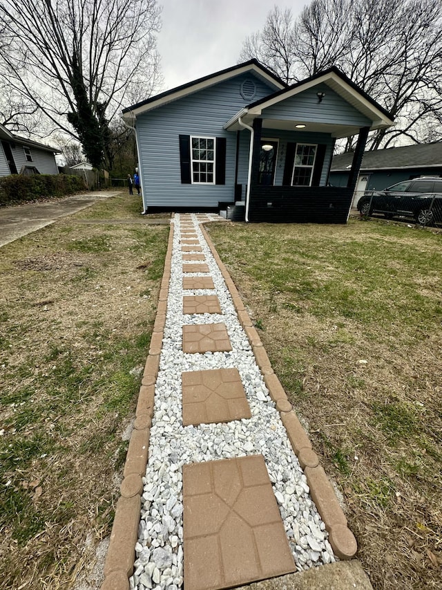 bungalow-style home featuring a front yard