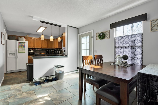 dining room featuring a textured ceiling