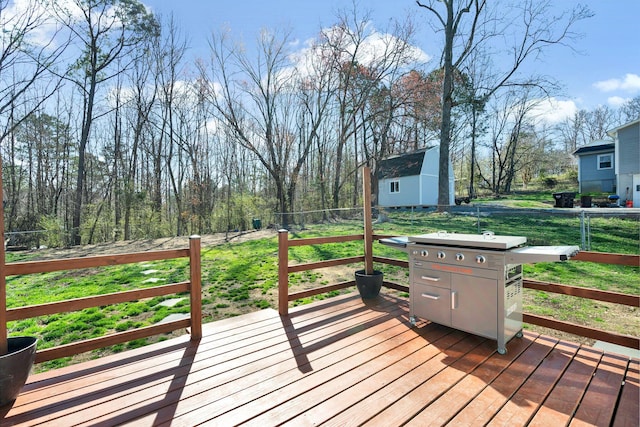 wooden terrace featuring a lawn