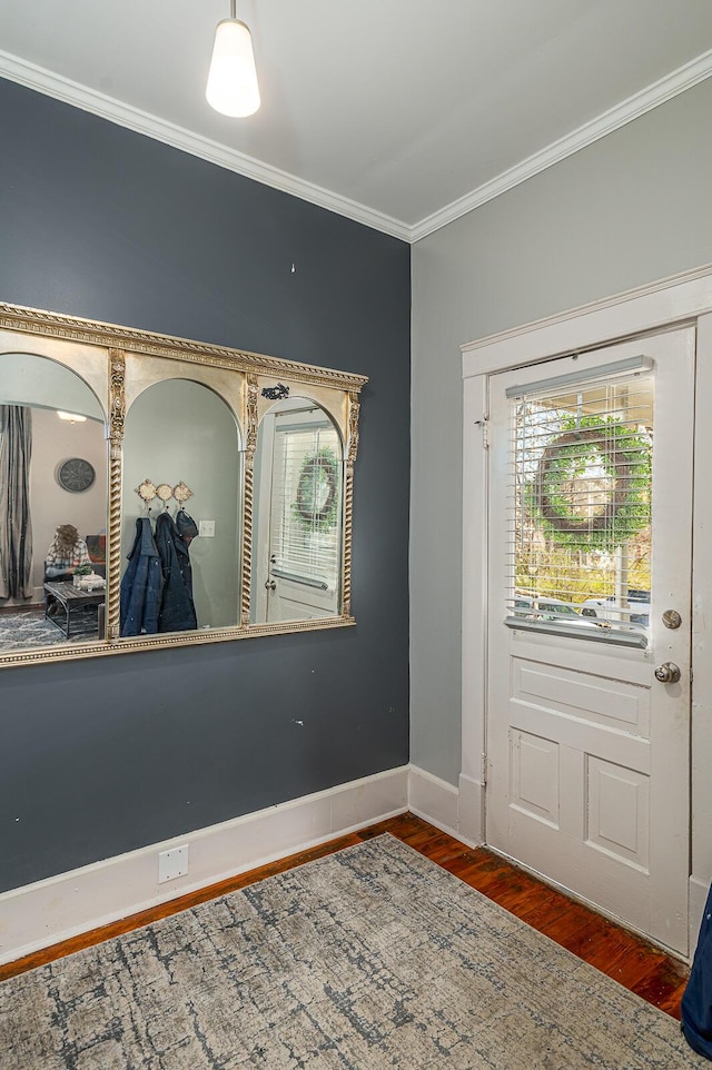 entryway featuring wood finished floors, baseboards, and ornamental molding