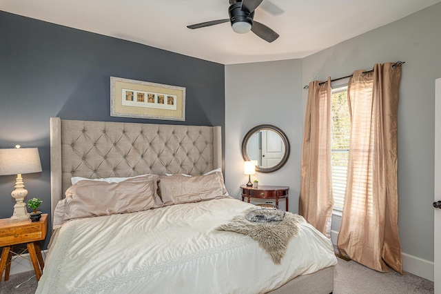 carpeted bedroom with a ceiling fan and baseboards