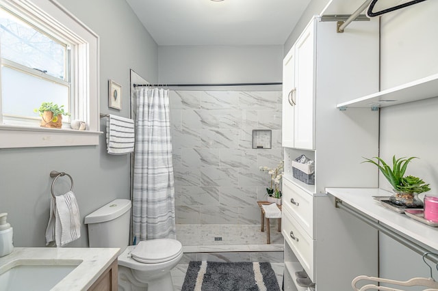 bathroom with vanity, toilet, and a stall shower