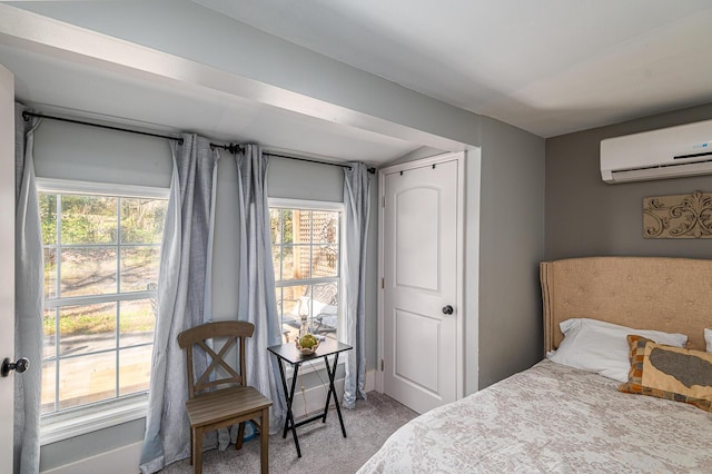 bedroom featuring light colored carpet and a wall unit AC