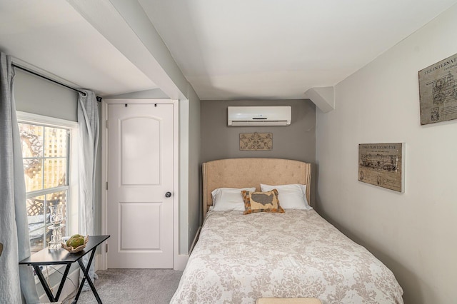 bedroom featuring a wall mounted air conditioner and carpet