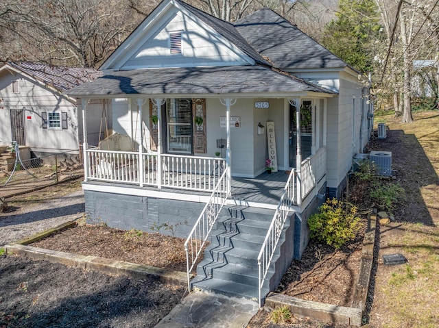 view of front of home featuring a porch, central AC, and roof with shingles