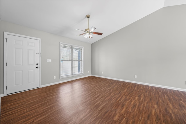 unfurnished living room featuring baseboards, dark wood finished floors, and vaulted ceiling