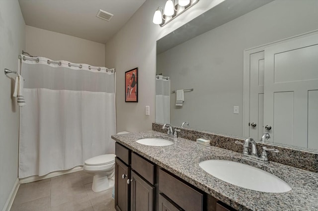 bathroom featuring tile patterned floors, toilet, visible vents, and a sink