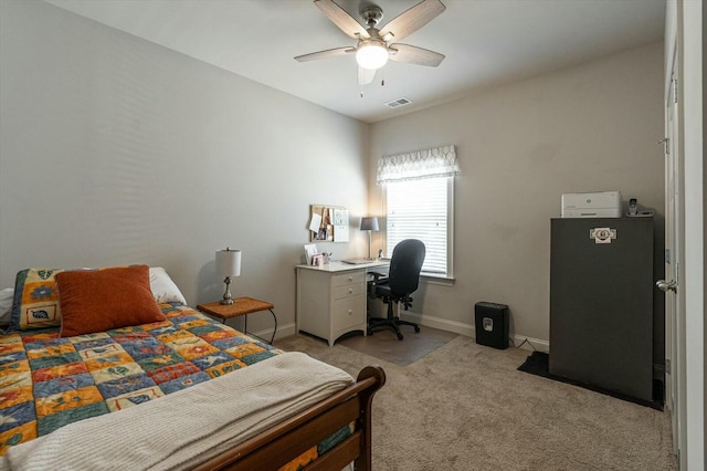 bedroom with visible vents, baseboards, light colored carpet, and a ceiling fan