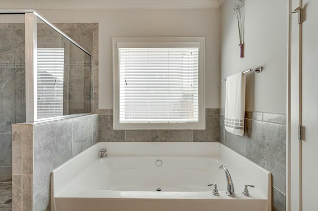 full bath featuring a shower stall and a garden tub