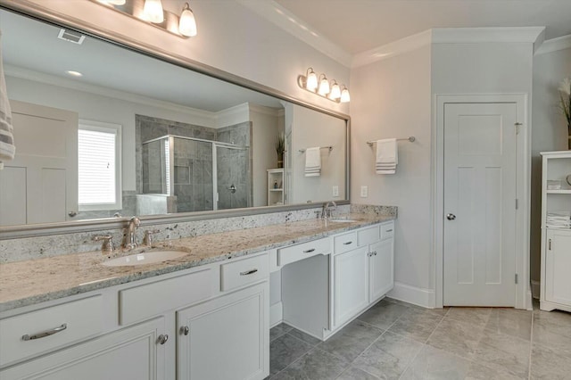 bathroom with a shower stall, crown molding, and a sink