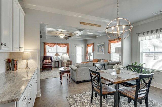 dining space featuring a wealth of natural light, wood finished floors, visible vents, and coffered ceiling