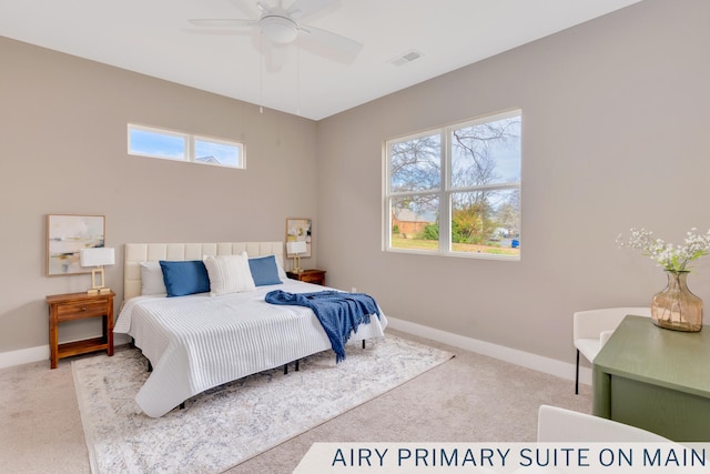 bedroom featuring multiple windows, carpet flooring, and visible vents