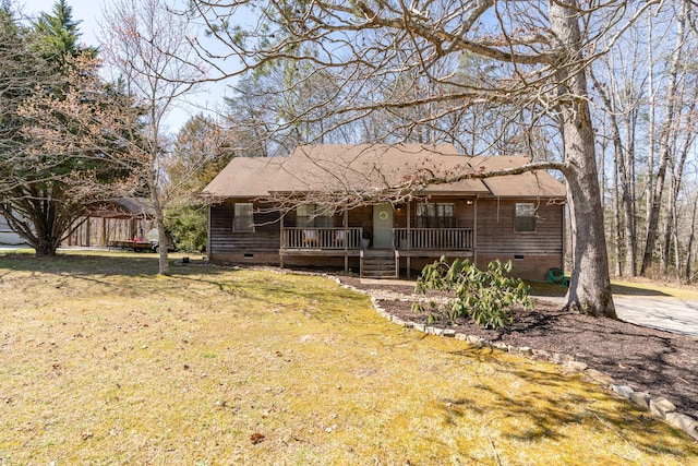 rear view of property with a yard, covered porch, and crawl space