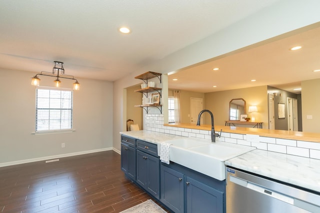 kitchen with a sink, recessed lighting, blue cabinets, and stainless steel dishwasher