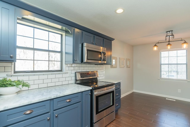 kitchen featuring decorative backsplash, appliances with stainless steel finishes, light countertops, and blue cabinets