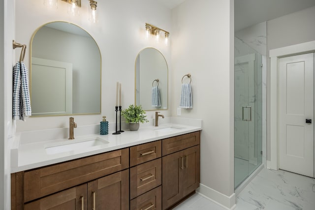 full bathroom with double vanity, marble finish floor, a marble finish shower, and a sink