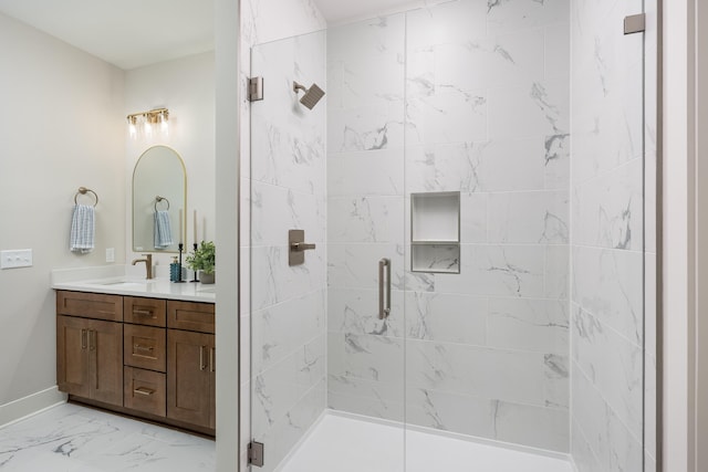bathroom with marble finish floor, a stall shower, vanity, and baseboards