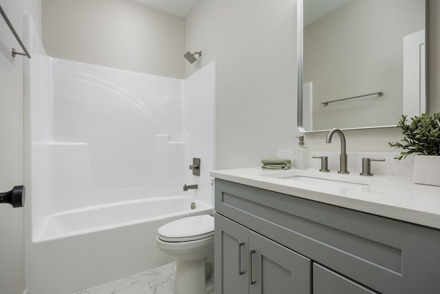 full bathroom with bathing tub / shower combination, toilet, marble finish floor, and vanity