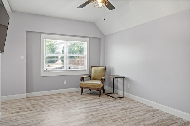 sitting room with light wood-type flooring, baseboards, lofted ceiling, and ceiling fan