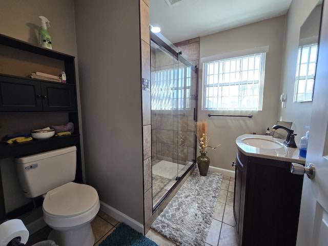 full bathroom with a stall shower, toilet, vanity, and baseboards