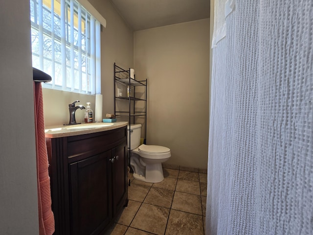 full bath featuring tile patterned flooring, a shower with shower curtain, toilet, and vanity