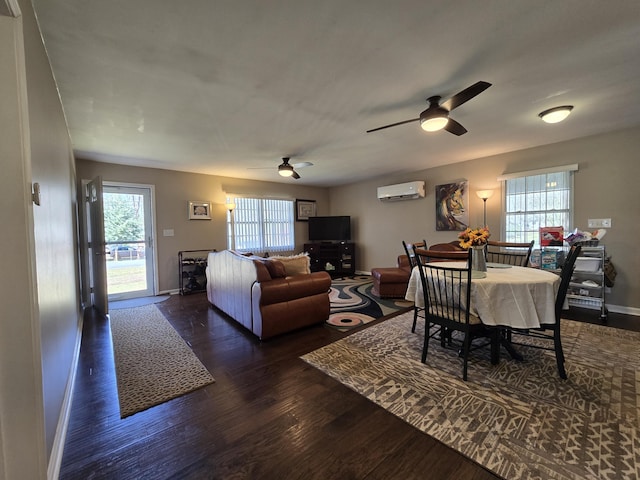 living area featuring a wall unit AC, wood finished floors, baseboards, and a wealth of natural light