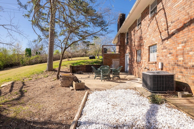 view of yard featuring central air condition unit and a patio