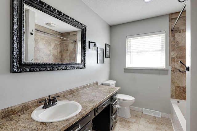 bathroom with visible vents, toilet, a textured ceiling, baseboards, and vanity