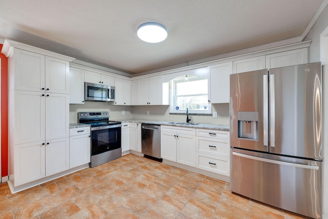 kitchen featuring a sink, white cabinets, and stainless steel appliances