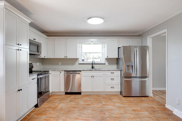 kitchen featuring visible vents, a sink, white cabinetry, appliances with stainless steel finishes, and light stone countertops