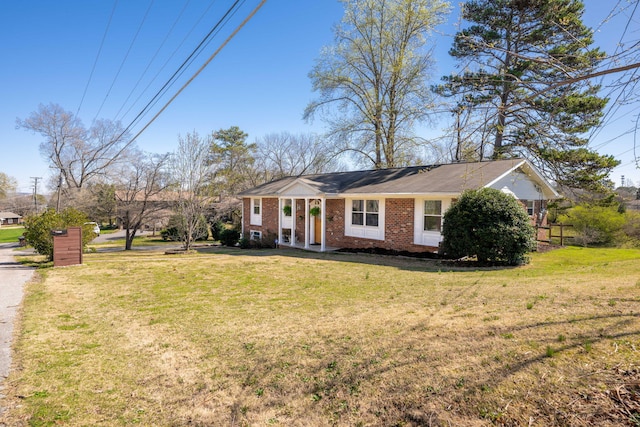 view of front facade with a front yard and brick siding