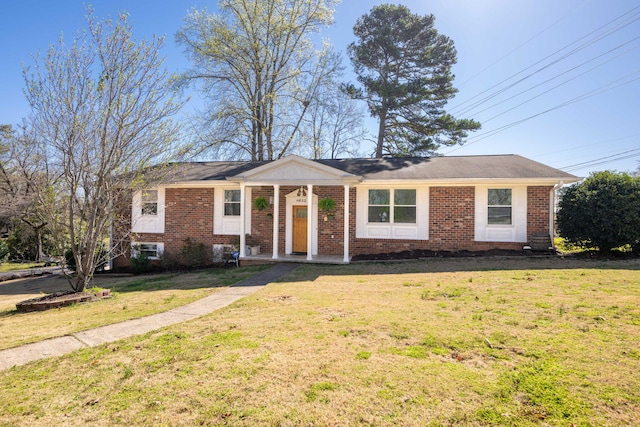 view of front of property with brick siding and a front lawn