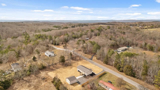 birds eye view of property featuring a view of trees and a rural view