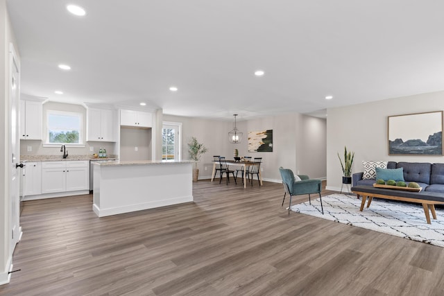 living room featuring recessed lighting, baseboards, and wood finished floors