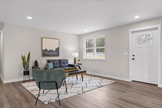 living room featuring recessed lighting, baseboards, and wood finished floors