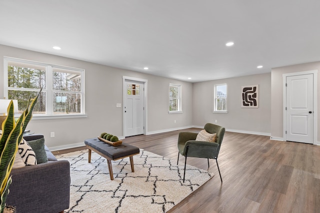 living room with recessed lighting, baseboards, and wood finished floors