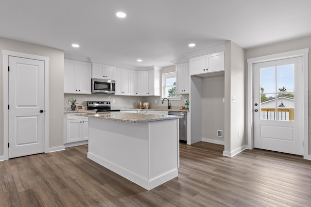 kitchen featuring dark wood finished floors, recessed lighting, white cabinetry, and stainless steel appliances